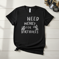 Need Money for Dirtbikes distressed chalk-style hand-pressed graphic tee on a black Gildan Softstyle shirt